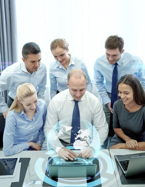 Smiling business people with laptop in office — Stock Photo, Image