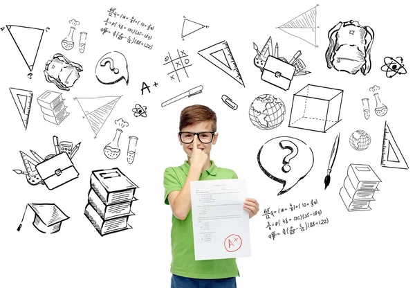 Happy boy in eyeglasses holding school test result — Stockfoto