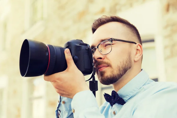 Mladá bederní muž s digitálním fotoaparátem v městě — Stock fotografie
