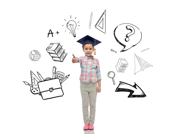 Happy girl in bachelor hat showing thumbs up — Stock Photo, Image