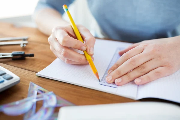 Close up of hands with ruler and pencil drawing — Stock Photo, Image