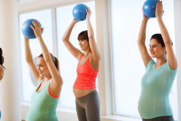 Mujeres embarazadas felices haciendo ejercicio con pelota en el gimnasio —  Fotos de Stock