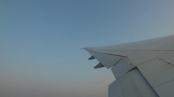 Wing of airplane flying in blue sky — Stock Video