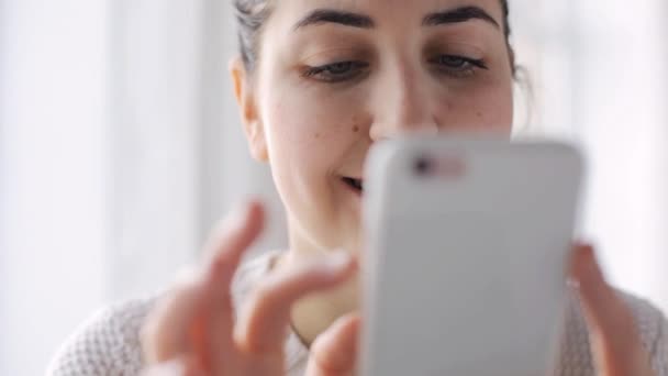 Gelukkige vrouw met smartphone thuis — Stockvideo