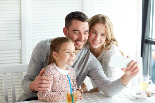 Happy family taking selfie at restaurant — Stock Photo, Image