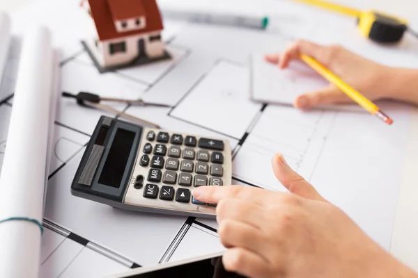 Close up of architect hand counting on calculator — Stock Photo, Image