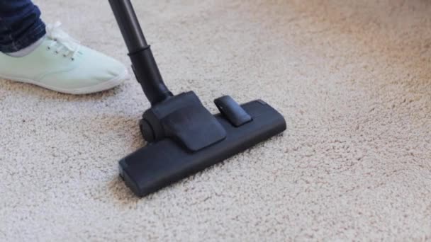 Woman with vacuum cleaner cleaning carpet at home — Stock Video