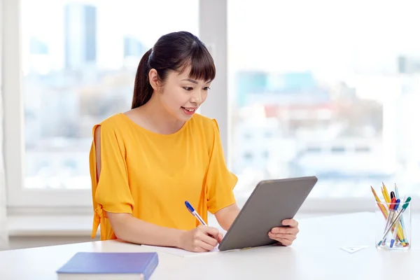 Asian woman student with tablet pc at home — Stock Photo, Image