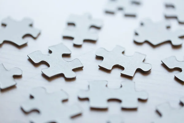 Close up of puzzle pieces on table — Stock Photo, Image