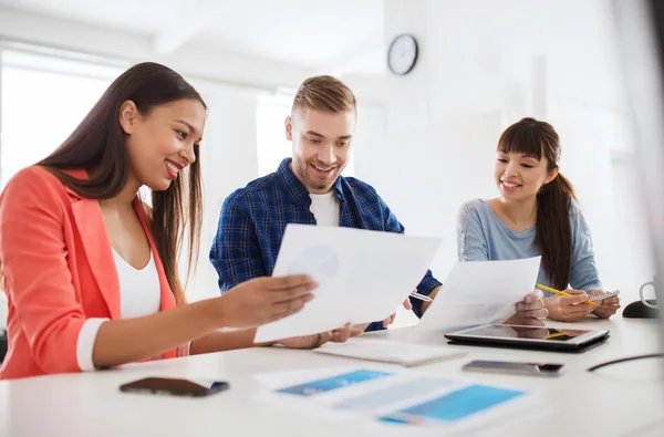 Feliz equipo creativo o estudiantes que trabajan en la oficina — Foto de Stock