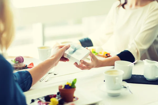 Gros plan de femmes donnant cadeau au restaurant — Photo