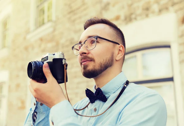 Young hipster man with film camera in city — Stock Photo, Image