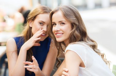 young women drinking coffee and talking at cafe clipart
