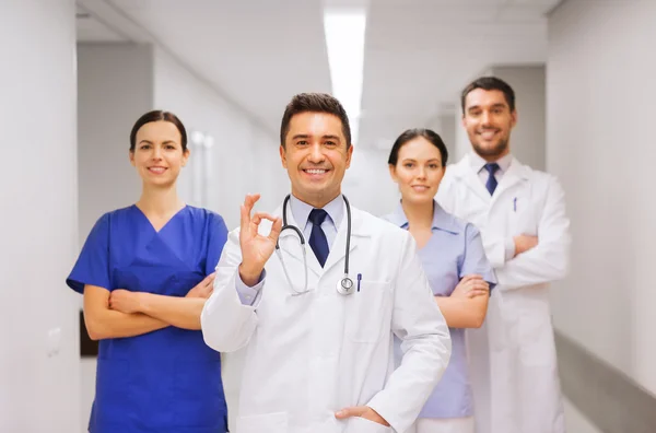 Group of medics at hospital showing ok hand sign — Stock Photo, Image