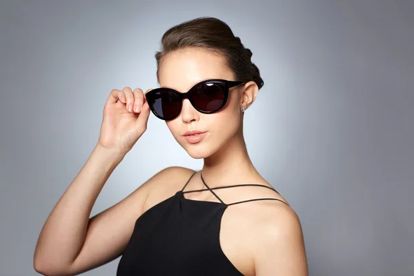 Bela jovem mulher em elegantes óculos de sol pretos — Fotografia de Stock