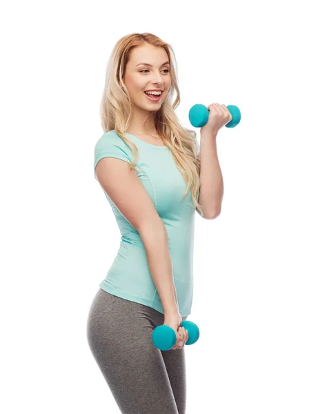 Happy beautiful young sporty woman with dumbbells — Stock Photo, Image