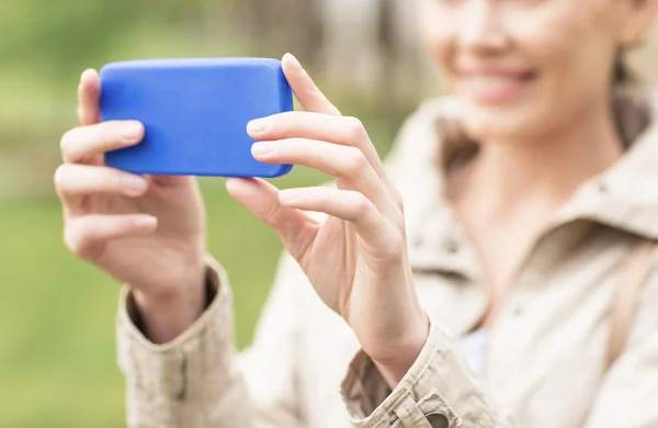 Close up of woman taking picture with smartphone — ストック写真