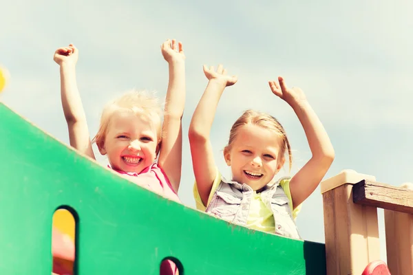 Niñas felices agitando las manos en el parque infantil —  Fotos de Stock