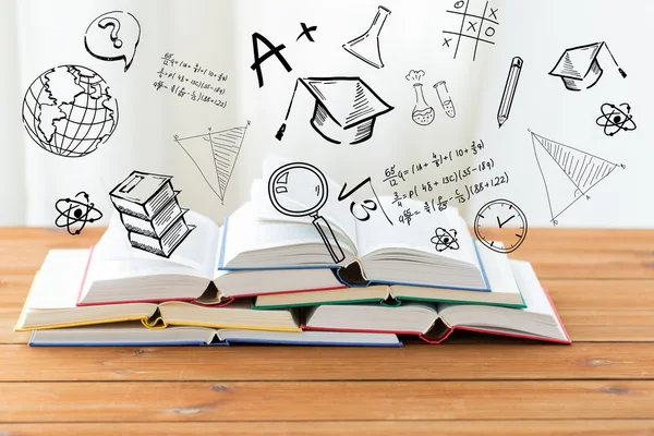 Close up of books on table over school doodles — Stock Photo, Image
