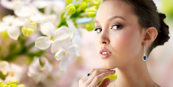 Beautiful woman with earring and finger ring — Stock Photo, Image