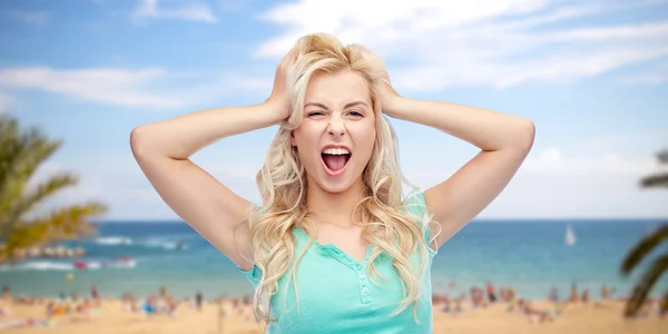 Smiling young woman holding to her head or hair — Stock Photo, Image