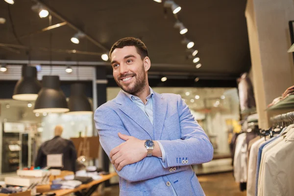 Happy young man in jacket at clothing store — Stock Photo, Image