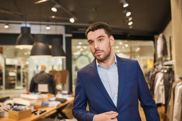 Young handsome man in jacket at clothing store — Stock Photo, Image