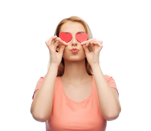 Happy young woman with red heart shapes on eyes — Stock Photo, Image