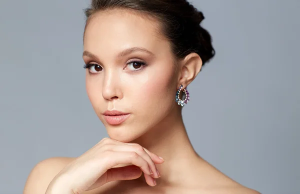 Close up of beautiful woman face with earring — Stock Photo, Image