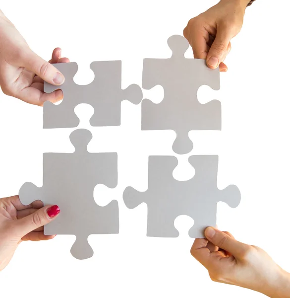 Close up of hands connecting puzzle pieces — Stock Photo, Image