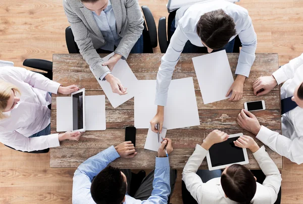 Close up of business team with papers and gadgets — Stock Photo, Image