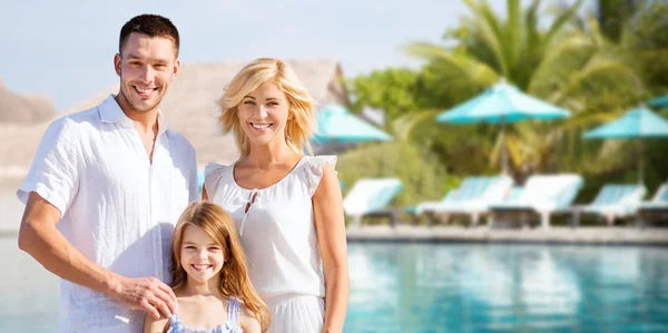 Happy family over hotel resort swimming pool — Stock Photo, Image