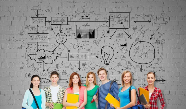 Group of teenage students with folders and bags — Stock Photo, Image