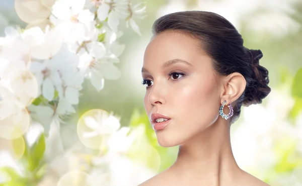 Close up of beautiful woman face with earring — Stock Photo, Image