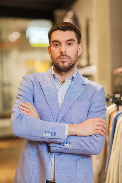 Young handsome man in jacket at clothing store — Stock Photo, Image