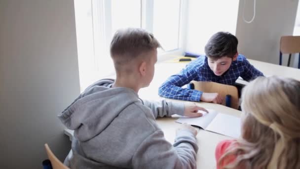 Students with notebooks on lesson at school — Stock Video