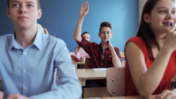 Студенти з блокнотами на уроці в школі — стокове відео