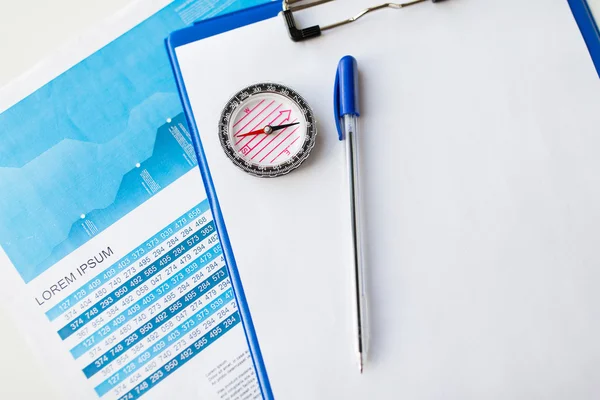 Close up of compass on financial report document — Stock Photo, Image