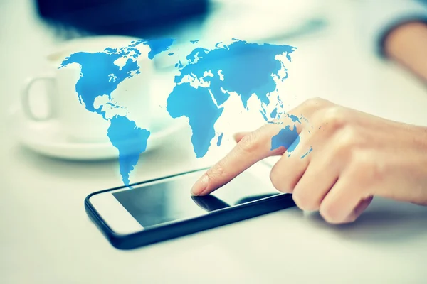 Close up of woman hand with smartphone and map — Stock Photo, Image