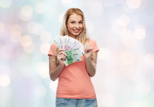 Feliz joven con dinero en efectivo en euros — Foto de Stock