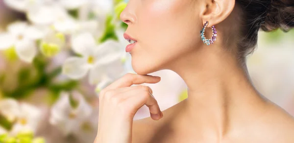 Close up of beautiful woman face with earring — Stock Photo, Image