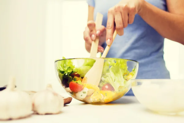 Close up of woman cooking vegetable salad at home — Stock Photo, Image