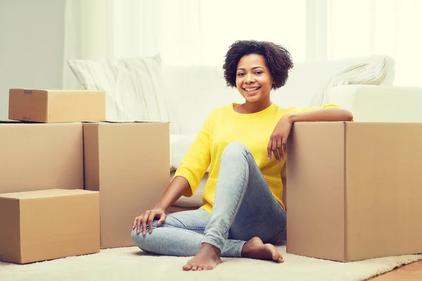 Gelukkig Afrikaanse vrouw met kartonnen dozen thuis — Stockfoto