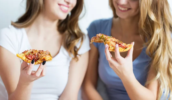 Happy přátelé nebo dospívající dívky jíst pizzu doma — Stock fotografie