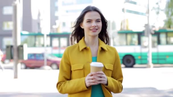 Happy young woman drinking coffee on city street — Stock Video
