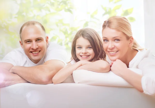 Smiling parents and little girl at home — Stock Photo, Image