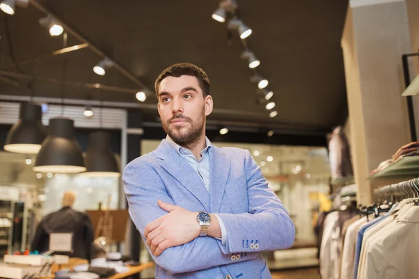 Happy young man in jacket at clothing store — Stock Photo, Image
