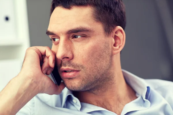 Face of young businessman calling on smartphone — Stock Photo, Image