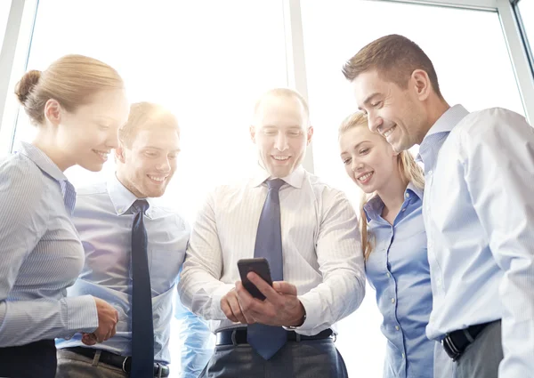 Happy businesspeople with smartphone — Stock Photo, Image