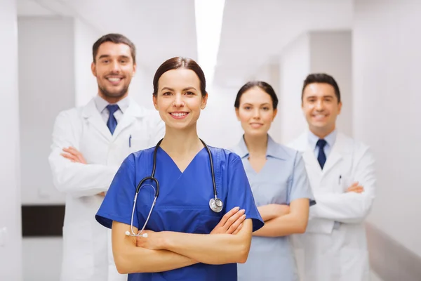 Happy group of medics or doctors at hospital — Stock Photo, Image